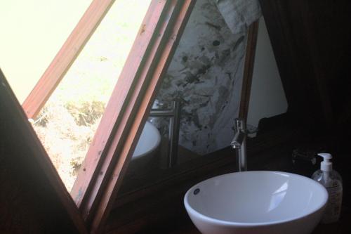 a bathroom with a large window and a sink at Glamping San Sebastian in Suesca