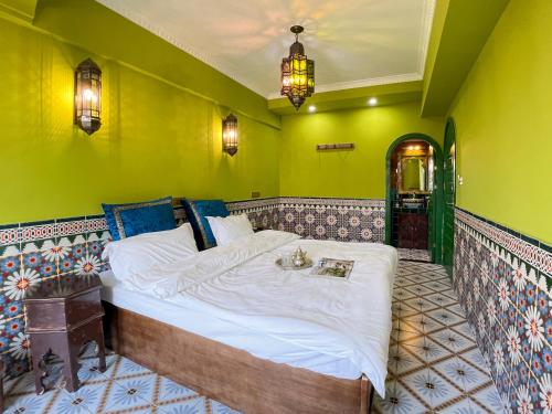 a bedroom with a bed in a room with green walls at The Arabian Nights B&B in Chongqing