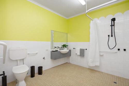 a bathroom with a sink and a toilet and a shower at Residence - White House Fitzroy in Melbourne