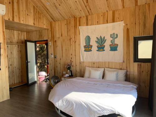 a bedroom with a bed in a room with wooden walls at Daisy SaPa - Venuestay in Sa Pa