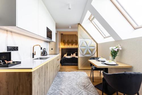 a kitchen and living room with skylights at Góralski Resort Family & SPA in Białka Tatrzanska