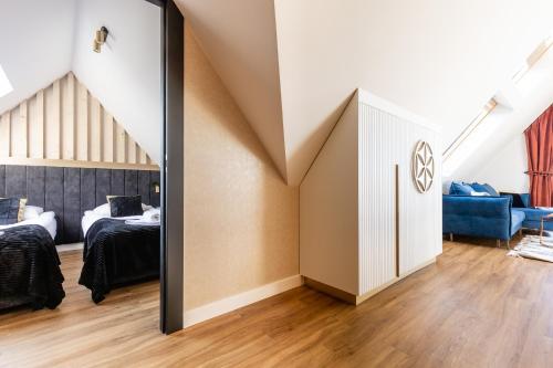 a mirror in a room with two beds at Góralski Resort Family & SPA in Białka Tatrzanska