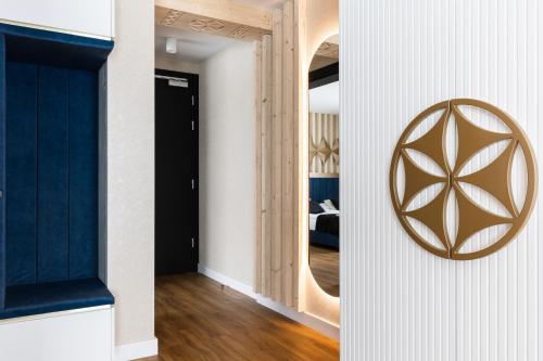 a hallway with a mirror and a room with a bed at Góralski Resort Family & SPA in Białka Tatrzanska