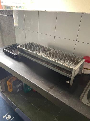 a metal rack sitting on top of a counter at Venice Raudhah Guest House in Lumut