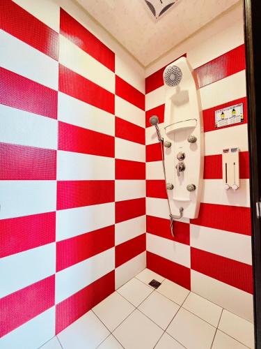a red and white striped bathroom with a sink at Ship House in Xiaoliuqiu