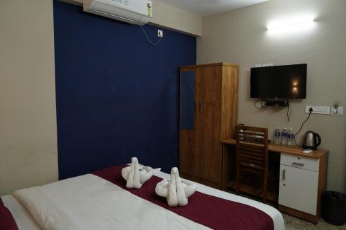 a hotel room with a bed with towels on it at Dreams Paradise Airport Residency in Nedumbassery