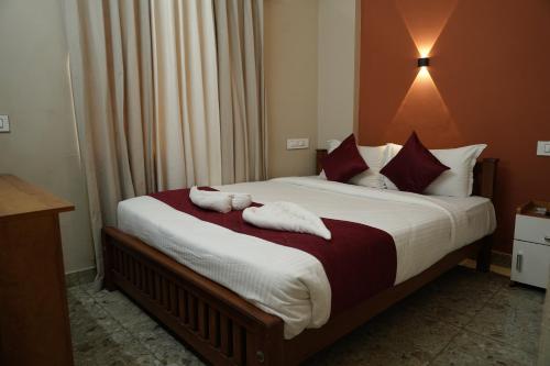 a bedroom with a bed with towels on it at Dreams Paradise Airport Residency in Nedumbassery