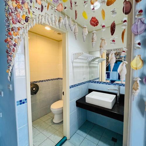 a bathroom with a sink and a toilet at Ship House in Xiaoliuqiu
