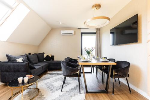a living room with a couch and a table at Góralski Resort Family & SPA in Białka Tatrzanska