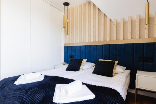 a bedroom with two beds with towels on them at Góralski Resort Family & SPA in Białka Tatrzanska