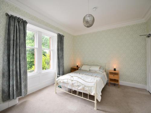 a bedroom with a bed and a window at Albion House in Castle Douglas
