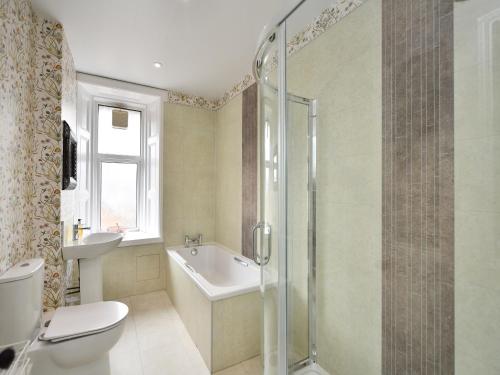 a bathroom with a shower and a toilet and a sink at Albion House in Castle Douglas