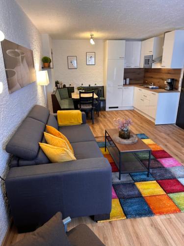 a living room with a couch and a kitchen at Weidach Zentrum in Leutasch