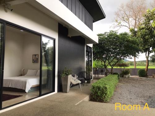 a bedroom on the side of a house at THE OAK’S in Chiang Rai
