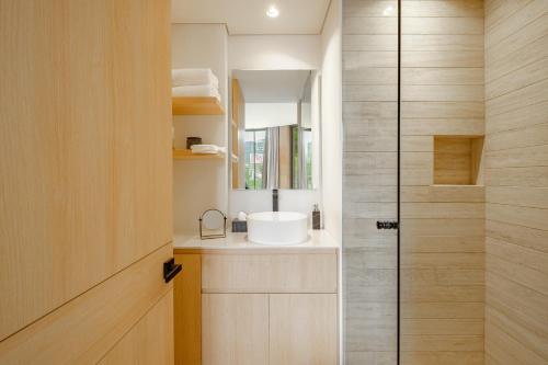 a bathroom with a sink and a shower at ONTO Tonalá Mexico City in Mexico City