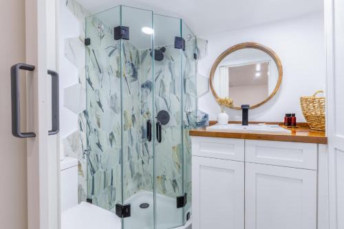 uma casa de banho com um chuveiro, um lavatório e um espelho. em Smart Tiny House Garden em Miami Gardens