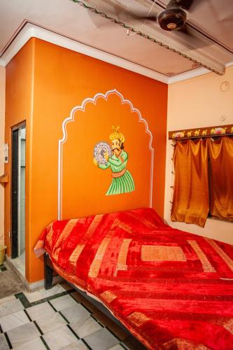 a bedroom with a bed with a painting on the wall at Hotel Everest in Pushkar