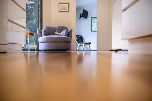 a living room with a couch and a chair at Driftwood in Coles Bay