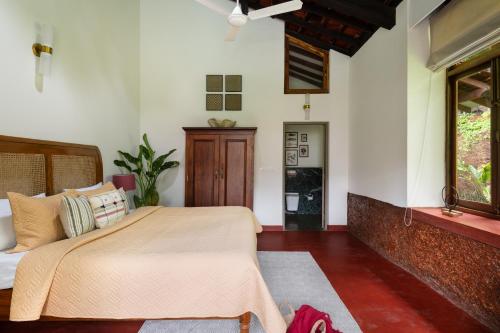 a bedroom with a bed and a window at Casa Desa Monteiro 4BHK Stand Alone Villa In Diwar Island with Complementary Breakfast & Private Pool, Garden, Fully Equipped Kitchen in Divar
