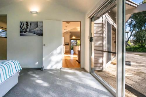 a glass door leading to a patio in a house at Driftwood in Coles Bay