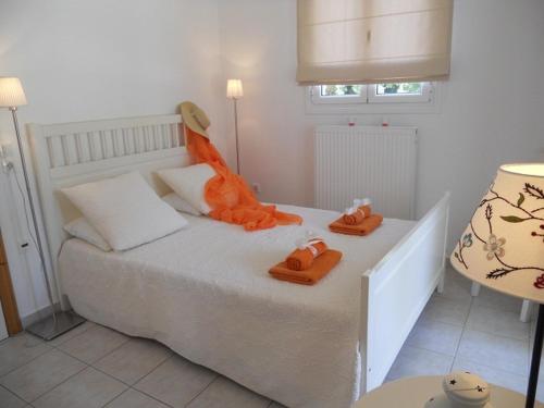 a bedroom with a bed with orange towels on it at Villa Fedrita in Acharavi