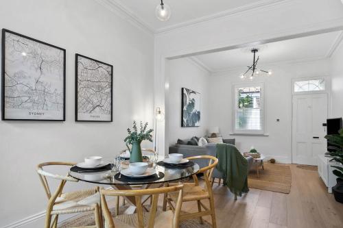 a dining room and living room with a table and chairs at 'The Enmore' - in the heart of everything Newtown in Sydney