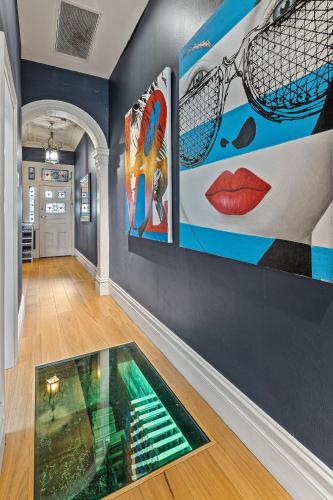 a room with paintings on the wall and a glass floor at Artscape, Newtown Villa in Sydney