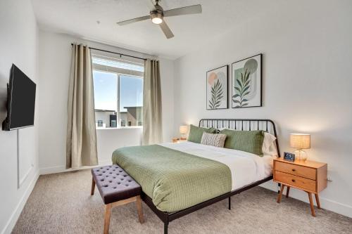 a bedroom with a bed and a flat screen tv at Brand New Lux Apartment - Year Round Pool - HAFB in Clearfield