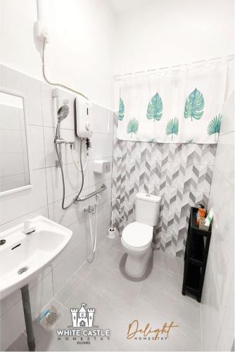 a bathroom with a white toilet and a sink at White Castle (Klg Baru) 11pax Semi-D Games/Neflix/Aeon in Kluang