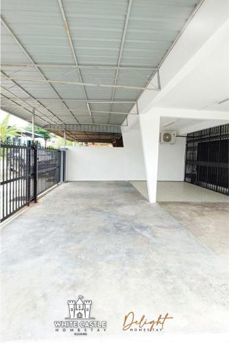 an empty parking lot with a white wall at White Castle (Klg Baru) 11pax Semi-D Games/Neflix/Aeon in Kluang