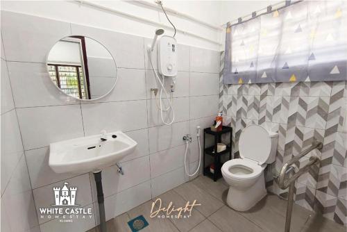 a bathroom with a toilet and a sink and a mirror at White Castle (Klg Baru) 11pax Semi-D Games/Neflix/Aeon in Kluang
