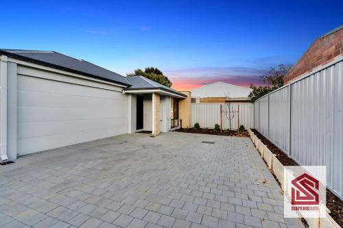 a house with a garage and a driveway at Bunbury Beach Splendor Modern Coastal Home in Bunbury