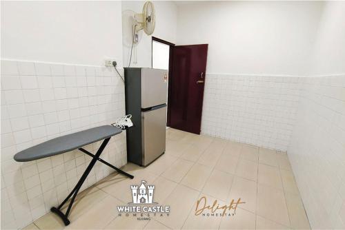 a room with a refrigerator in a white tile wall at White Castle (Klg Baru) 11pax Semi-D Games/Neflix/Aeon in Kluang