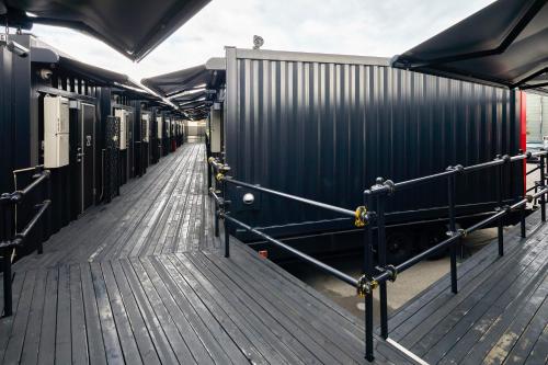 a row of train cars on a wooden deck at HOTEL R9 The Yard Tokoname in Tokoname