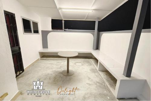 a small room with a table and a stool at White Castle (Klg Baru) 11pax Semi-D Games/Neflix/Aeon in Kluang
