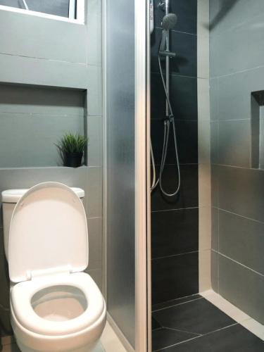 a bathroom with a toilet and a shower at Cozy Suite - Near UTAR - Champs Elysees Kampar in Kampar