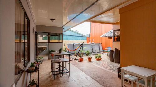 an indoor patio with a table and chairs in a building at Casa Las Tres Marias in Fortuna