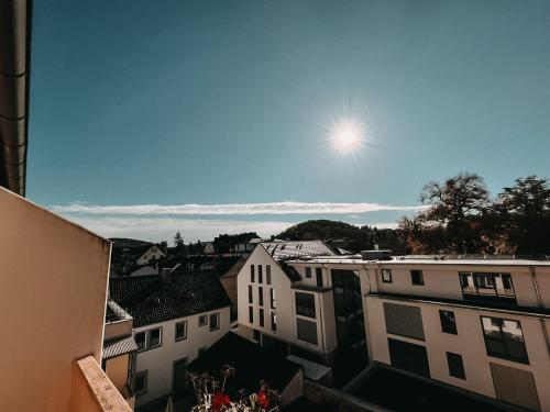 a view of a city with the sun in the sky at Hotel Bayerischer Hof in Bad Kissingen