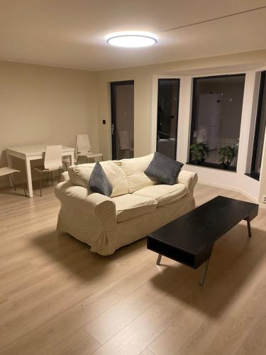 uma sala de estar com um sofá e uma mesa em Rom # 1 Appartmenthotell Oslo em Oslo