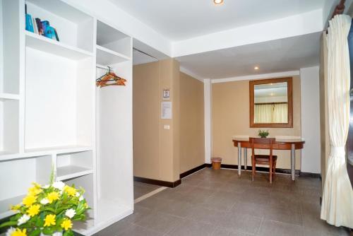 a hallway with a desk and a table in a room at The Florist Resort in Mae Nam