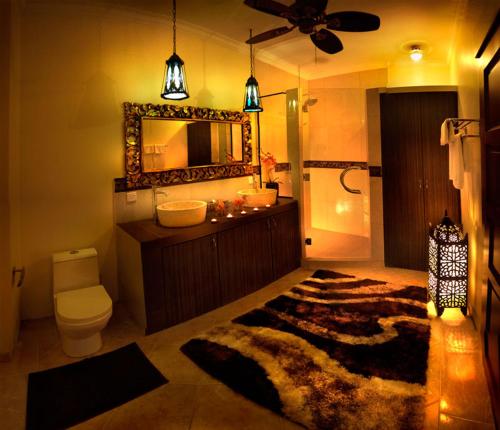 uma casa de banho com um lavatório, WC e um espelho. em Tempat Senang Spa Resort & Restaurant em Sekupang