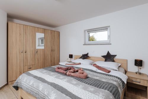 a bedroom with a bed with two towels on it at Tanja s Holiday Home in Nature with sauna and hot tub in Gorica pri Slivnici