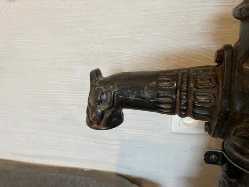 an old metal gun hanging on a wall at Loft by Conceptliving in Kortrijk