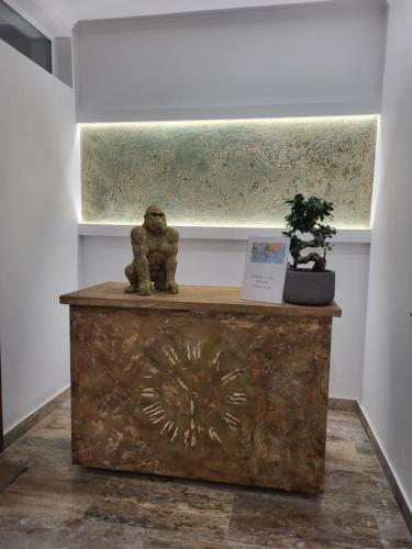 a statue of a bear sitting on top of a chest at Sika Grand Palladium Garden & Spa Central Apartment Arad in Arad