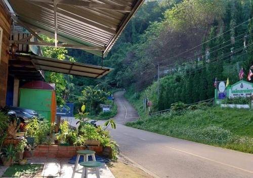 a view of a road with a building on the side at Ban Oreo Homestay in Ban Pha Hu