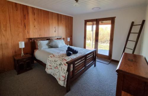 a bedroom with a bed with a stuffed animal on it at Chandlers Rest 