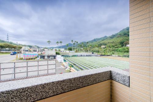 a balcony with a view of a parking lot at Quan Ming B&B in Dahu