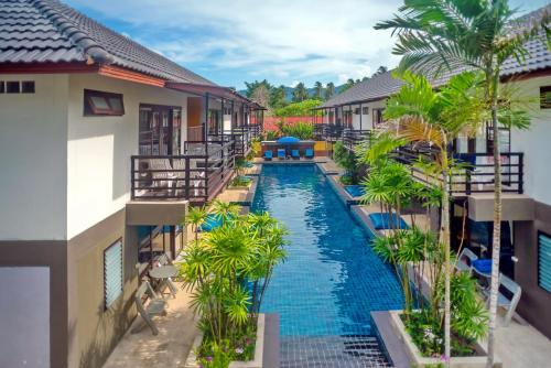 an aerial view of a resort pool with palm trees at The Florist Resort in Mae Nam