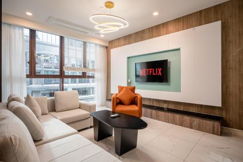 a living room with a couch and a table at Metropole Thu Thiem Condo Apartment in Ho Chi Minh City