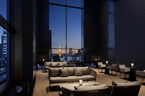 a room with couches and tables in a building at AC Hotel by Marriott Tokyo Ginza in Tokyo